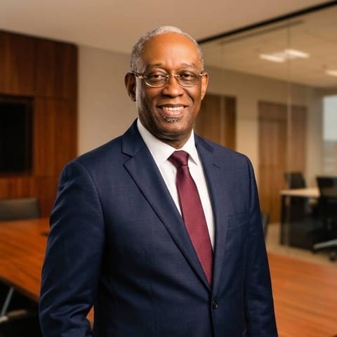 Dr Rex Al Opusunju in a navy suit
